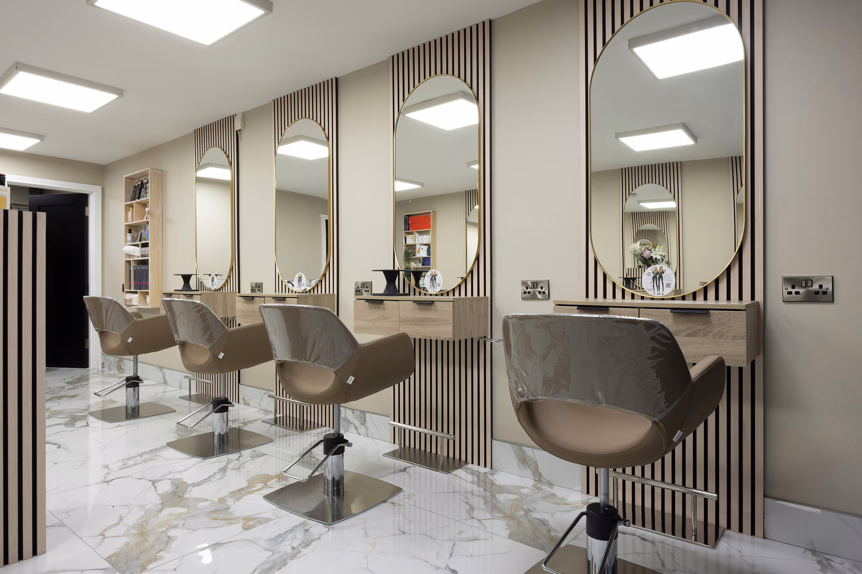 BrowBone Makeover studio interior with mirrors, beauty stations and salon chairs
