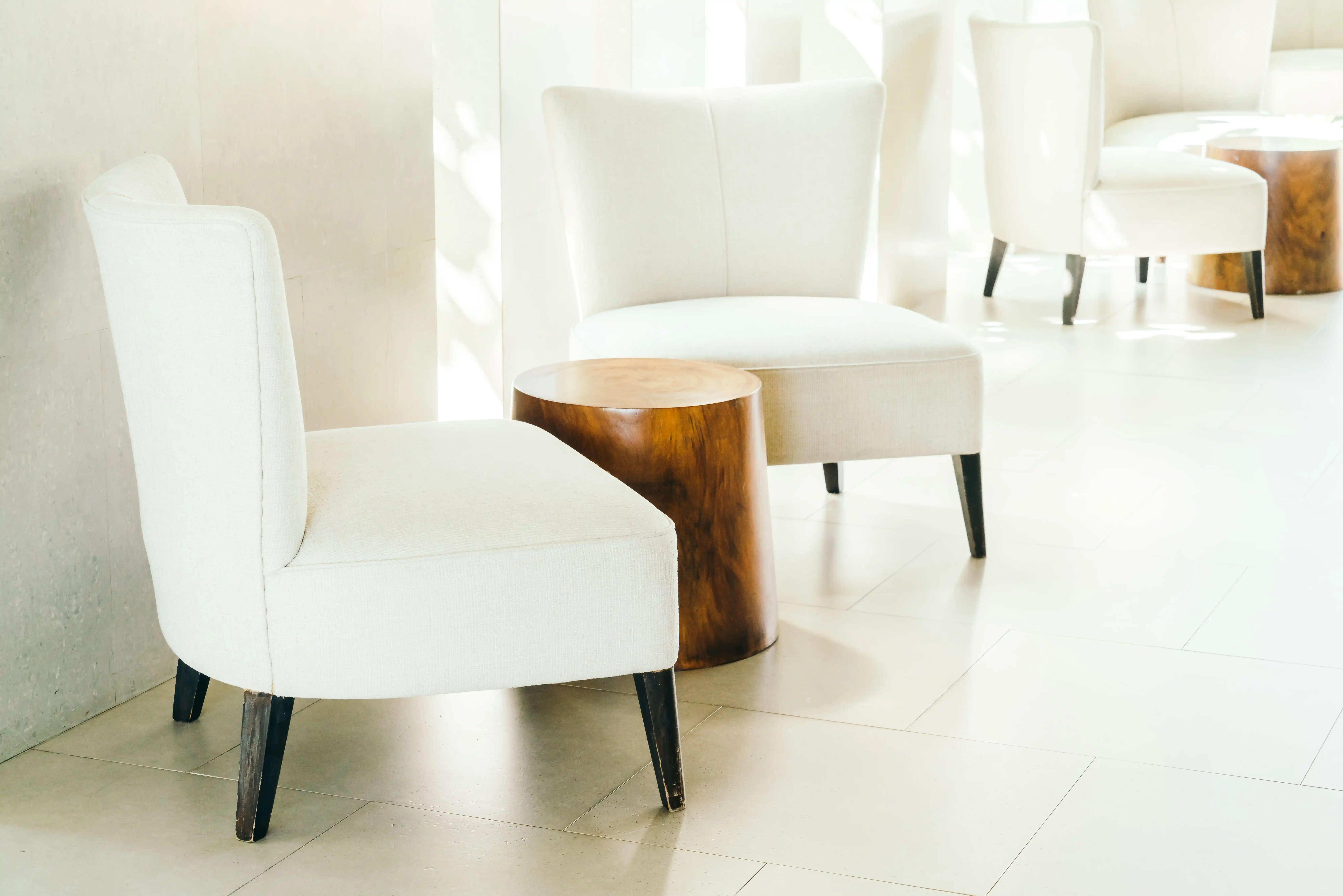 BrowBone beauty studio seating area with elegant chairs and a round wooden table