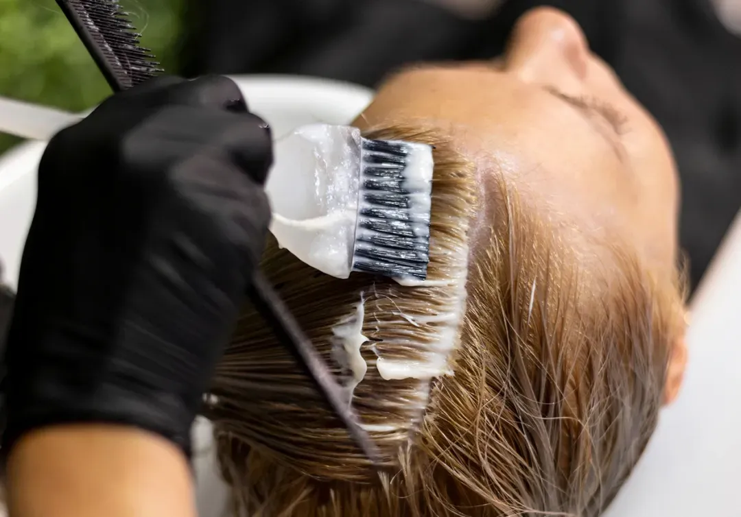 Professional hair colour treatment being applied in a beauty salon